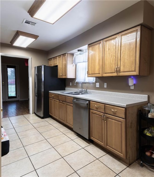 kitchen featuring light wood-type flooring, sink, refrigerator, and dishwasher