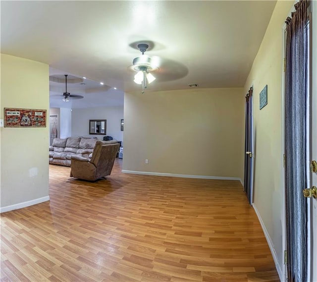 living room featuring ceiling fan and light hardwood / wood-style floors