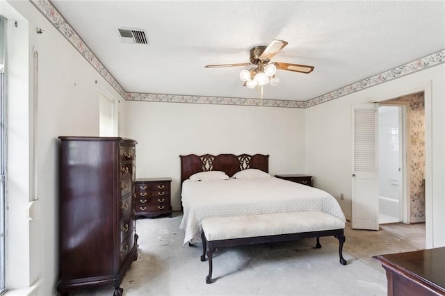 bedroom with ceiling fan and a textured ceiling