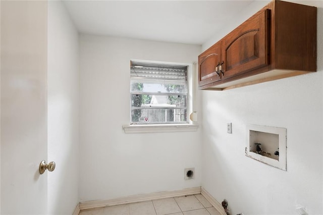 laundry area with light tile patterned floors, cabinets, hookup for a washing machine, and electric dryer hookup