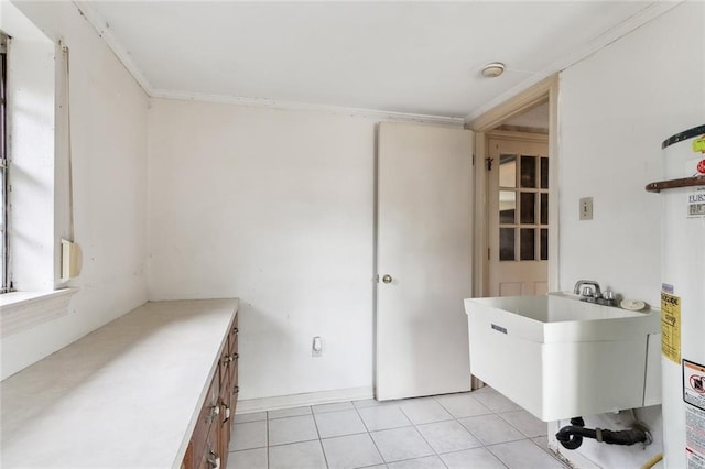 laundry room featuring light tile patterned flooring, sink, and ornamental molding