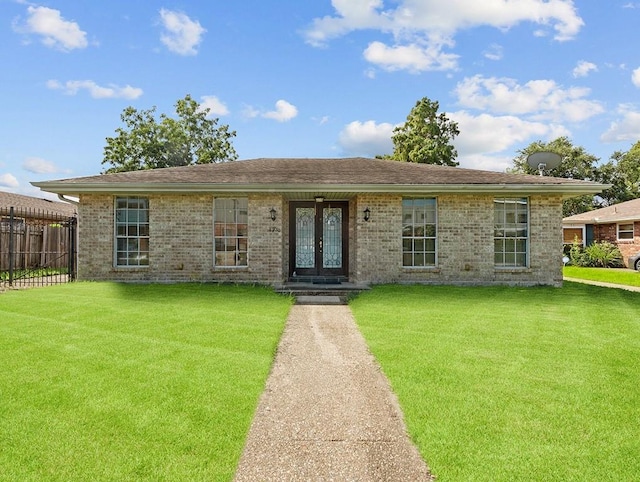 single story home featuring a front yard and french doors