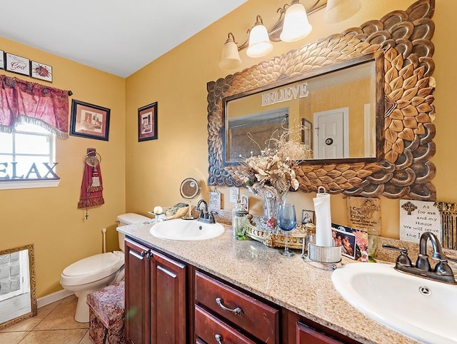 bathroom with dual vanity, tile patterned flooring, and toilet