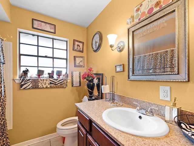 bathroom with tile patterned floors, vanity, and toilet