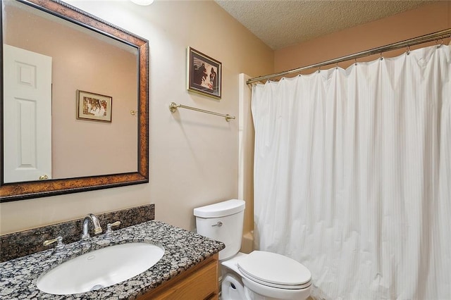 bathroom with vanity, a textured ceiling, and toilet