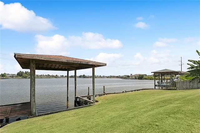 dock area with a yard, a water view, and a gazebo