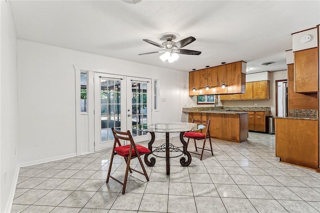 kitchen featuring french doors, sink, ceiling fan, light tile patterned floors, and kitchen peninsula