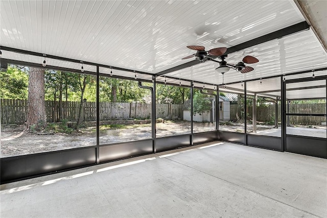 unfurnished sunroom with ceiling fan