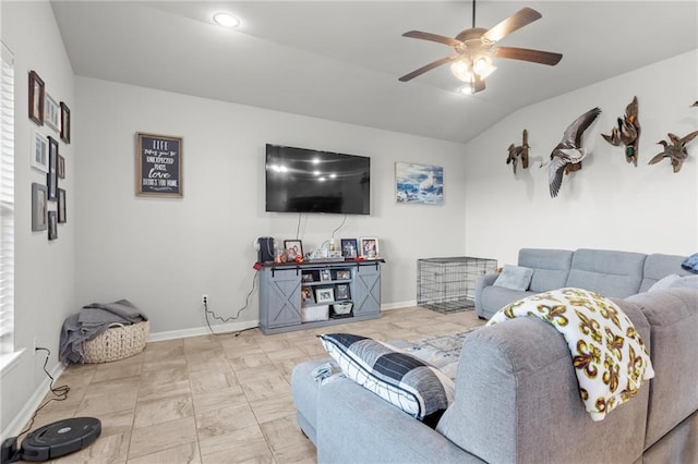 tiled living room with ceiling fan and lofted ceiling