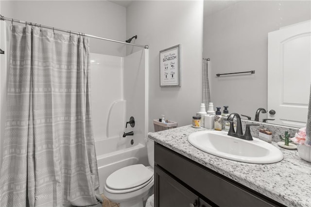 full bathroom featuring shower / bath combo, vanity, and toilet