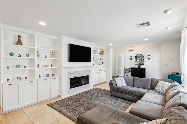 tiled living room featuring a fireplace and built in features