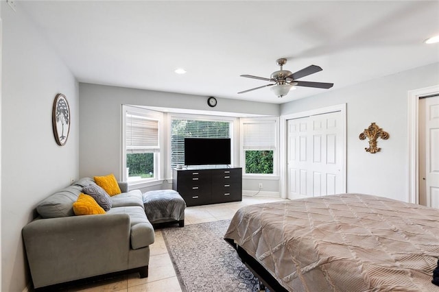 tiled bedroom with ceiling fan