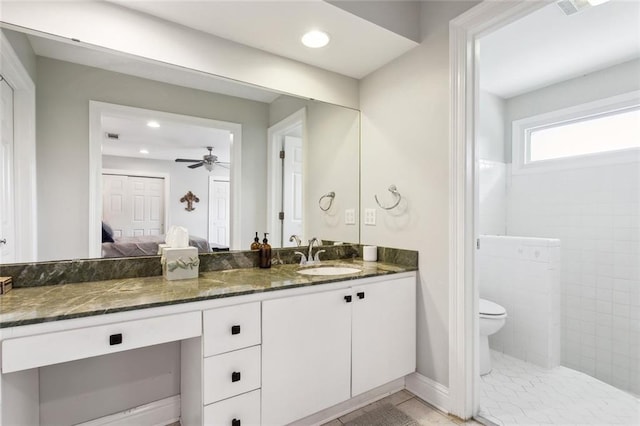 bathroom featuring ceiling fan, tile patterned floors, vanity, and toilet