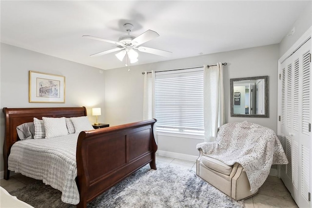 tiled bedroom with a closet and ceiling fan