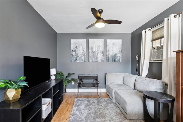 living room with ceiling fan and light hardwood / wood-style flooring