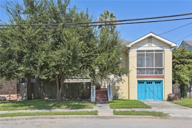 3722 Nashville Ave, New Orleans, LA 70125 - view of front facade featuring fence, driveway, a garage, and stucco siding