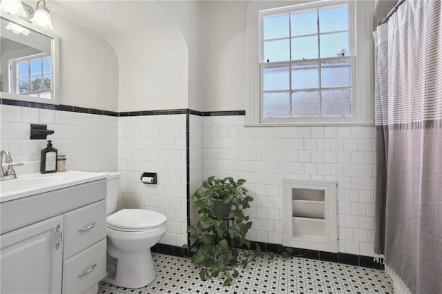 bathroom featuring tile walls, vanity, and tile patterned flooring