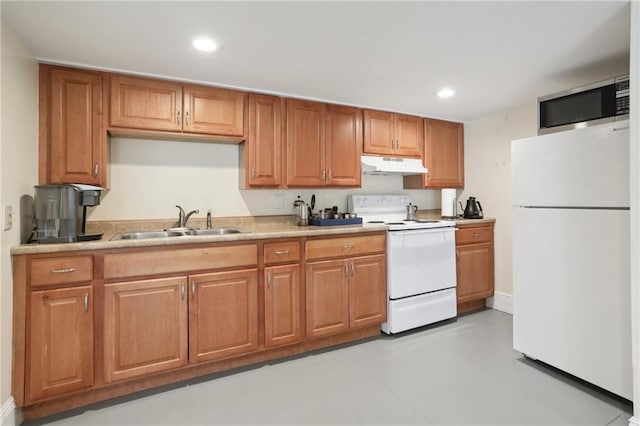 3722 Nashville Ave, New Orleans, LA 70125 - kitchen with recessed lighting, brown cabinets, under cabinet range hood, a sink, and white appliances