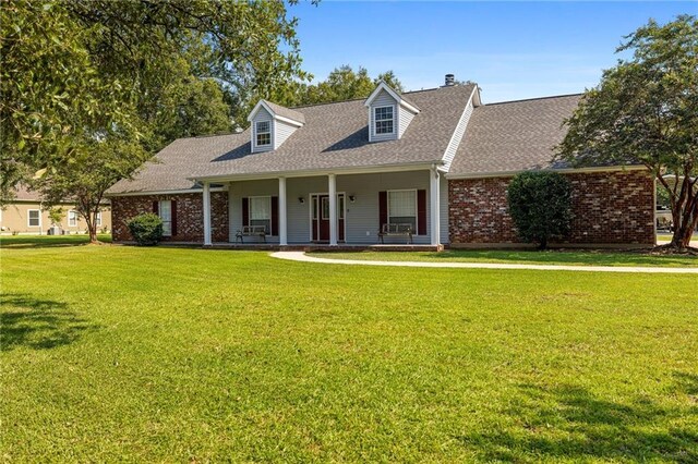 cape cod home with a front lawn