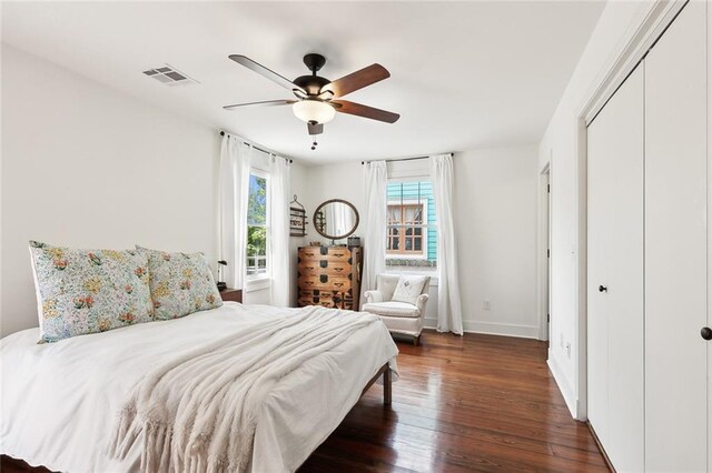 bedroom featuring dark hardwood / wood-style floors, a closet, and ceiling fan