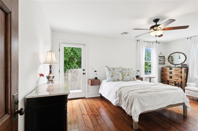 bedroom with access to outside, dark hardwood / wood-style floors, and ceiling fan