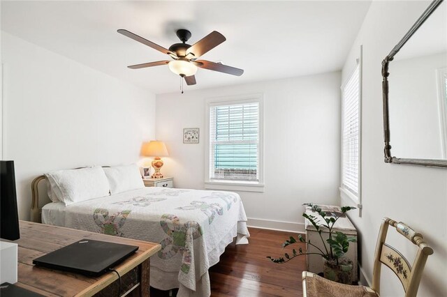 bedroom with ceiling fan and dark hardwood / wood-style floors