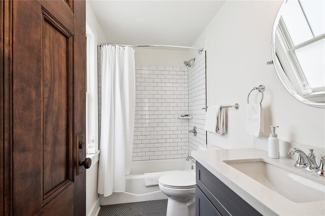 full bathroom featuring shower / tub combo with curtain, tile patterned flooring, vanity, and toilet