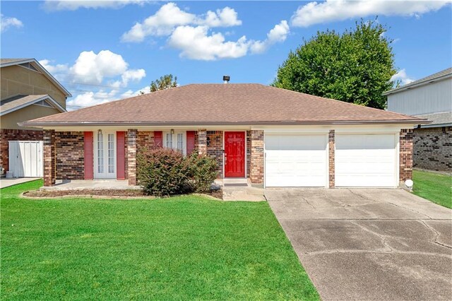 view of front of home with a garage, french doors, and a front yard