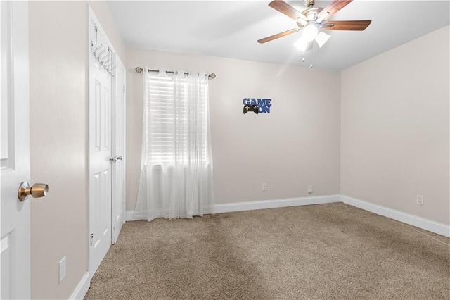 unfurnished room featuring ceiling fan and light carpet