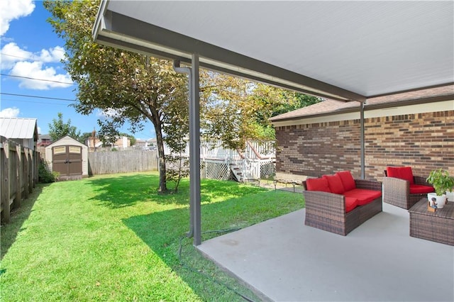 view of yard featuring outdoor lounge area, a patio, and a storage unit