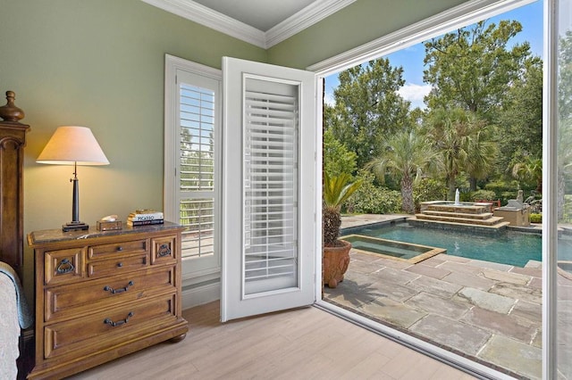 doorway to outside with wood finished floors and ornamental molding