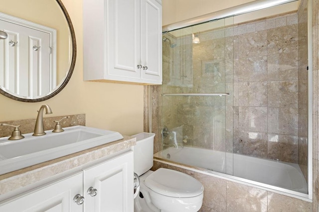 full bathroom with tiled shower / bath, toilet, and vanity