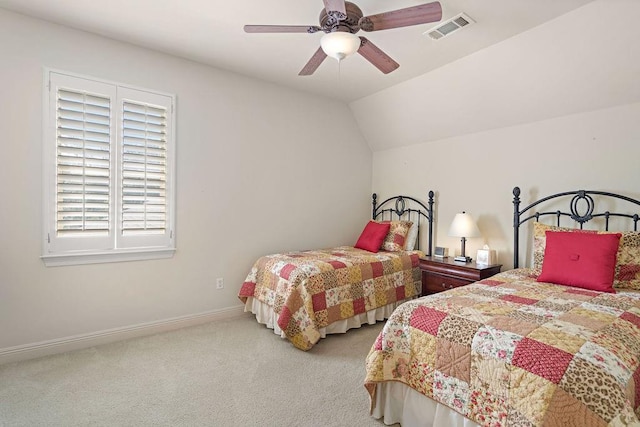 carpeted bedroom with visible vents, lofted ceiling, baseboards, and ceiling fan