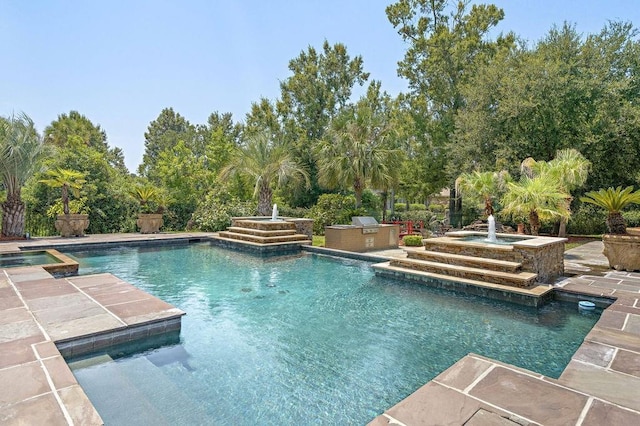 view of pool featuring exterior kitchen and a pool with connected hot tub