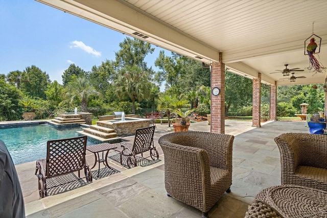 view of patio featuring an outdoor pool and a ceiling fan