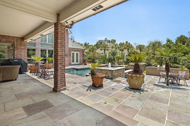 view of patio with an outdoor pool, french doors, and a grill