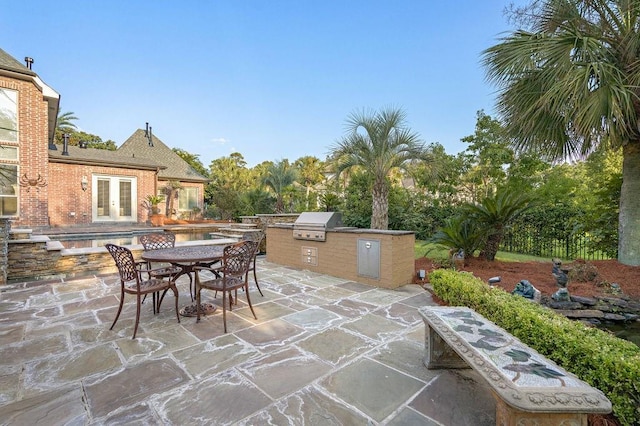 view of patio / terrace featuring area for grilling, an outdoor kitchen, and a pool