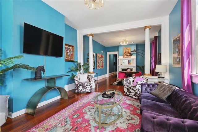 living room with decorative columns and dark hardwood / wood-style floors