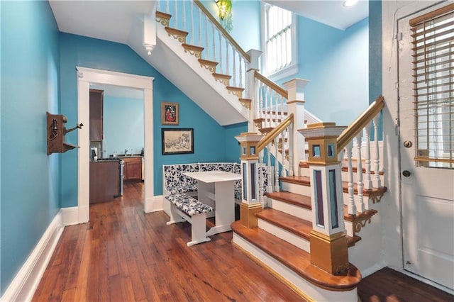 stairway featuring hardwood / wood-style flooring and a wealth of natural light