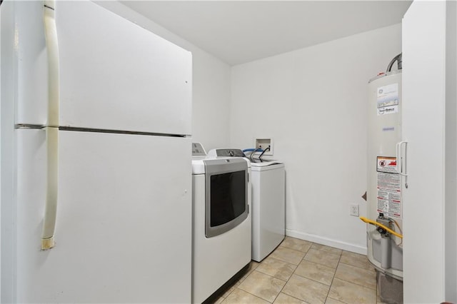 laundry room with washing machine and dryer, gas water heater, and light tile patterned flooring