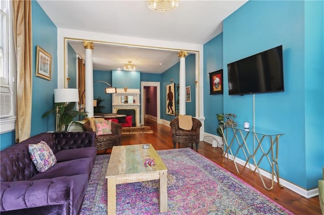 living room featuring wood-type flooring and decorative columns