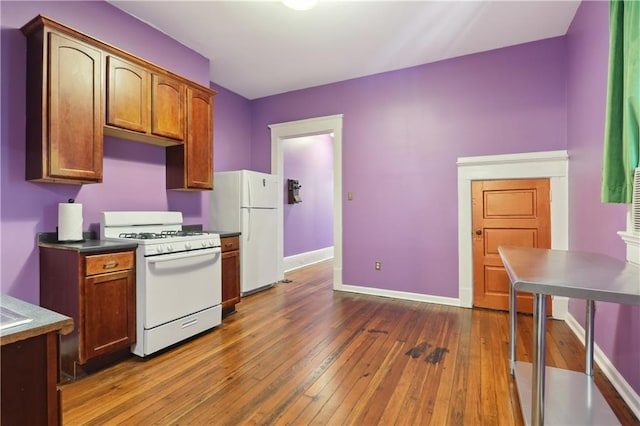 kitchen featuring white appliances and hardwood / wood-style flooring