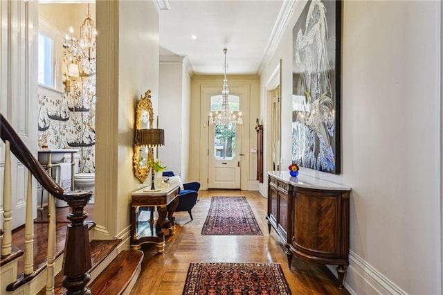 foyer with a chandelier, crown molding, and wood-type flooring