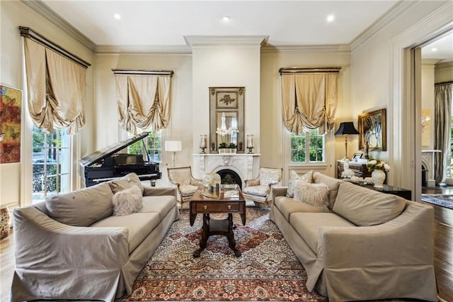 living room featuring hardwood / wood-style flooring, a wealth of natural light, and crown molding