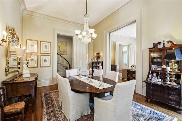 dining area featuring ornamental molding, dark wood-type flooring, and a notable chandelier