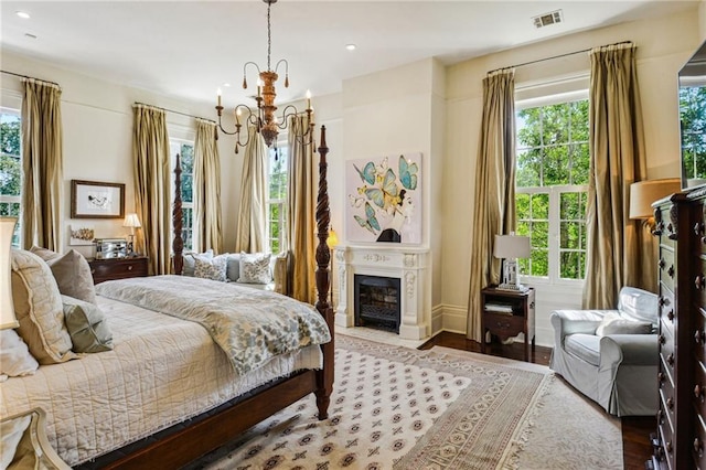 bedroom featuring hardwood / wood-style floors and a notable chandelier