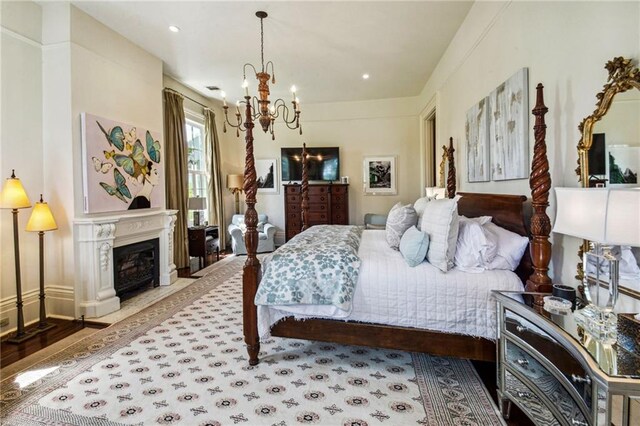 bedroom featuring hardwood / wood-style flooring and an inviting chandelier