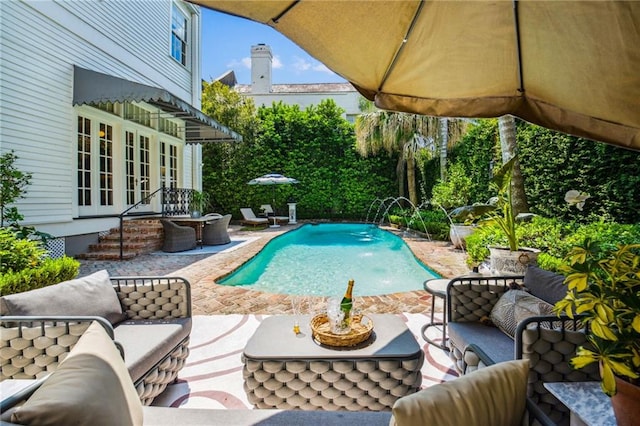 view of pool featuring french doors, an outdoor hangout area, pool water feature, and a patio area