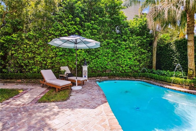 view of pool featuring pool water feature and a patio area