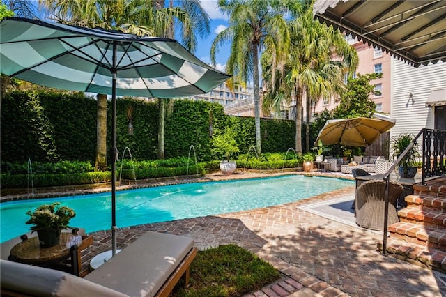 view of swimming pool with a patio area and pool water feature